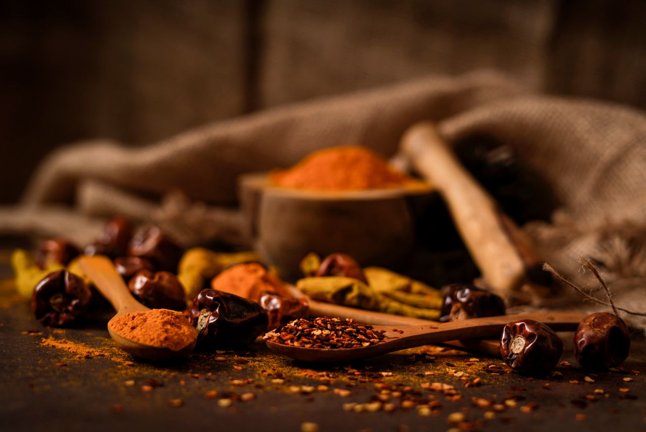 The Art of Drawing Readers In: Your attractive post title goes here A close-up of rustic spices such as chilies and turmeric on wooden spoons, highlighting food textures.